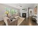 Bright living room featuring a fireplace, large windows, and hardwood floors at 1605 Silo Point Dr, Wake Forest, NC 27587