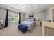 Calming main bedroom with tray ceiling, carpet, natural light, and a blue bench at the foot of the bed at 1605 Silo Point Dr, Wake Forest, NC 27587