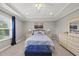 Serene main bedroom with tray ceiling, carpet, and a large window for natural light at 1605 Silo Point Dr, Wake Forest, NC 27587
