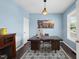 Bright office space featuring blue walls, hardwood floors, and a large, modern desk at 1605 Silo Point Dr, Wake Forest, NC 27587