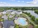 Aerial view of a community pool area with a lake and walking path in the background at 1605 Silo Point Dr, Wake Forest, NC 27587