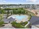 Aerial view of a community pool with chairs, tables and mature landscaping at 1605 Silo Point Dr, Wake Forest, NC 27587