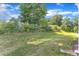 Spacious backyard with a large grassy area and trees at 1665 Wilde Bnd, Apex, NC 27523