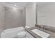 Well-lit bathroom featuring a shower over tub, gray tiled surround, and granite countertop vanity at 1665 Wilde Bnd, Apex, NC 27523