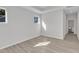 A bedroom featuring hardwood floors, lots of natural light, and neutral paint with laundry visible in the background at 1665 Wilde Bnd, Apex, NC 27523