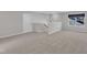 Spacious bonus room featuring neutral carpet, a window and staircase access at 1665 Wilde Bnd, Apex, NC 27523