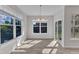 Bright dining area with hardwood floors, a chandelier, and large windows providing ample natural light at 1665 Wilde Bnd, Apex, NC 27523