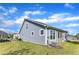 Exterior side view of a blue house with a screened porch and grassy yard at 1665 Wilde Bnd, Apex, NC 27523