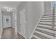 The foyer boasts hardwood floors, white trim and a staircase leading to the upper level at 1665 Wilde Bnd, Apex, NC 27523