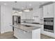 Spacious kitchen featuring stainless steel appliances, ample counter space and a convenient center island at 1665 Wilde Bnd, Apex, NC 27523