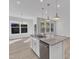 Kitchen island featuring light countertops and stainless steel appliances, perfect for meal preparation and entertaining at 1665 Wilde Bnd, Apex, NC 27523