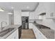 Beautiful kitchen features stainless appliances, white cabinetry, granite countertops and convenient island at 1665 Wilde Bnd, Apex, NC 27523