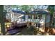 Spacious backyard with a wooden deck, mature trees, and lush greenery at 1700 Laura Duncan Rd, Apex, NC 27502