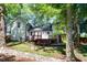 Home's backyard featuring a wooden deck and well-maintained lawn at 1700 Laura Duncan Rd, Apex, NC 27502