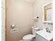 Cozy half-bathroom featuring grey vanity, toilet and light fixture, perfect for guests at 1700 Laura Duncan Rd, Apex, NC 27502