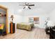 Cozy bedroom featuring wood floors, a ceiling fan, and a bright window at 1700 Laura Duncan Rd, Apex, NC 27502