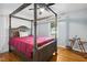 Bedroom showcases a four poster bed, wood floors and natural light at 1700 Laura Duncan Rd, Apex, NC 27502
