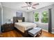A bedroom featuring hardwood floors, neutral colored walls and a large window at 1700 Laura Duncan Rd, Apex, NC 27502