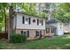 Charming house with brick detailing, black shutters, and a well-manicured lawn at 1700 Laura Duncan Rd, Apex, NC 27502
