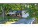 Aerial view of a home with mature trees, a driveway, and well-maintained landscaping at 1700 Laura Duncan Rd, Apex, NC 27502