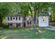 Inviting home with lush green lawn, mature trees, and a brick and siding facade at 1700 Laura Duncan Rd, Apex, NC 27502