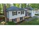 Two-story house featuring brick accents, black shutters, and well-maintained landscaping at 1700 Laura Duncan Rd, Apex, NC 27502