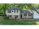 Charming two-story home with brick and siding exterior and black shutters at 1700 Laura Duncan Rd, Apex, NC 27502