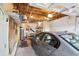 Organized garage featuring a parked car, exposed ceiling, shelving, and ample workspace at 1700 Laura Duncan Rd, Apex, NC 27502