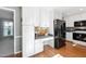Eat-in kitchen boasts a dedicated desk space, stainless steel appliances, and hardwood floors for comfort and functionality at 1700 Laura Duncan Rd, Apex, NC 27502