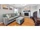 Inviting living room with brick fireplace, cozy sofa, ottoman, and hardwood flooring, creating a comfortable space at 1700 Laura Duncan Rd, Apex, NC 27502