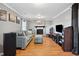 Comfortable living room with gray brick fireplace, blue sofa, ottoman, and hardwood flooring, creating a relaxing space at 1700 Laura Duncan Rd, Apex, NC 27502