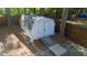 Outdoor white storage shed with a ramp surrounded by a lush forest setting and mature trees at 1700 Laura Duncan Rd, Apex, NC 27502