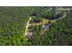 Aerial view of a home nestled in a wooded neighborhood with winding streets at 197 Boxwood Dr, Pittsboro, NC 27312