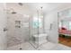 Bathroom with a glass shower, a soaking tub, and elegant fixtures at 197 Boxwood Dr, Pittsboro, NC 27312