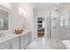 Luxurious bathroom with double vanity, walk-in shower, and marble flooring at 197 Boxwood Dr, Pittsboro, NC 27312