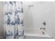 Clean bathroom with white tub and unique sailboat themed curtain at 197 Boxwood Dr, Pittsboro, NC 27312
