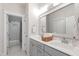 Bathroom with gray cabinets, double vanity, modern fixtures, and view into the subway tiled shower at 197 Boxwood Dr, Pittsboro, NC 27312