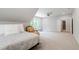 Large bedroom with neutral carpet, dormer window, ceiling fan, and bright seating area at 197 Boxwood Dr, Pittsboro, NC 27312