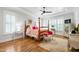 Spacious bedroom with tray ceilings, natural light, hardwood floors, and stylish furnishings at 197 Boxwood Dr, Pittsboro, NC 27312