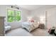 Bright bedroom features a large window, a neutral carpet, and white furniture at 197 Boxwood Dr, Pittsboro, NC 27312
