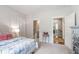 Light bedroom boasts a white bed, view to the ensuite bathroom, and view to the stairs at 197 Boxwood Dr, Pittsboro, NC 27312