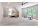 Spacious bedroom with plush carpet, dormer window, ceiling fan, and ample natural light at 197 Boxwood Dr, Pittsboro, NC 27312