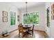 Charming breakfast nook with large windows offering scenic views, hardwood floors and a decorative chandelier at 197 Boxwood Dr, Pittsboro, NC 27312