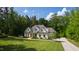 Beautifully landscaped home with lush green lawn and mature trees on a sunny day at 197 Boxwood Dr, Pittsboro, NC 27312