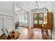 Bright foyer with hardwood floors, elegant lighting, and views into the dining room and front entrance at 197 Boxwood Dr, Pittsboro, NC 27312