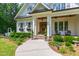Charming home features a covered front porch, manicured landscaping, and inviting entrance at 197 Boxwood Dr, Pittsboro, NC 27312
