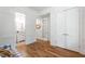Hallway features wainscotting, wood floors, and a view into the bathroom and another room at 197 Boxwood Dr, Pittsboro, NC 27312