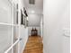 Hallway features wood floors, white walls, crown molding, and French doors at 197 Boxwood Dr, Pittsboro, NC 27312