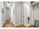 Hallway featuring hardwood floors and access to the laundry and other rooms at 197 Boxwood Dr, Pittsboro, NC 27312