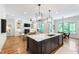 Spacious open-concept kitchen with an island, connecting to the living room and breakfast nook, hardwood floors and elegant design at 197 Boxwood Dr, Pittsboro, NC 27312